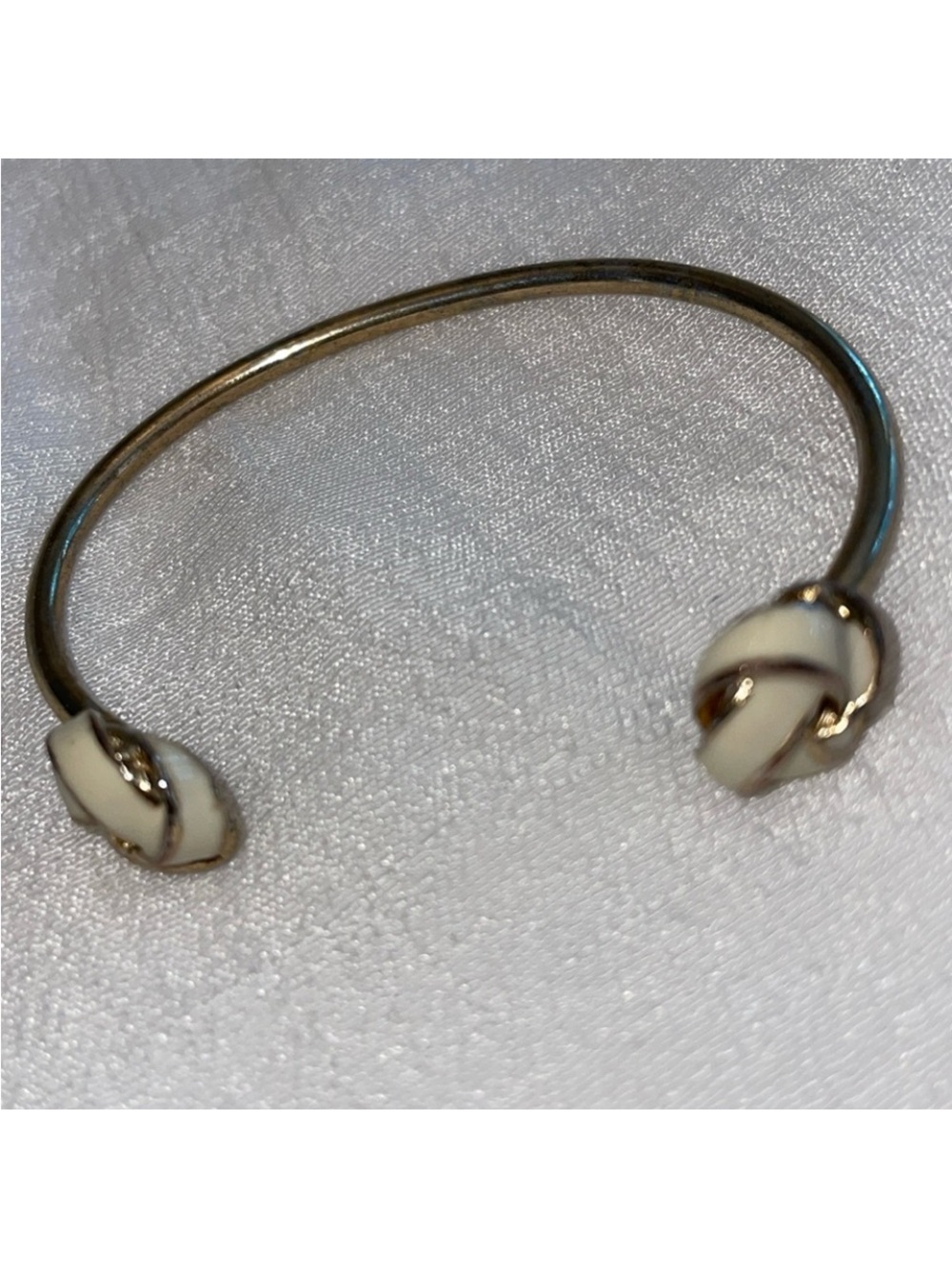 Gold-Tone Open Cuff Bracelet with Cream Knot Ends